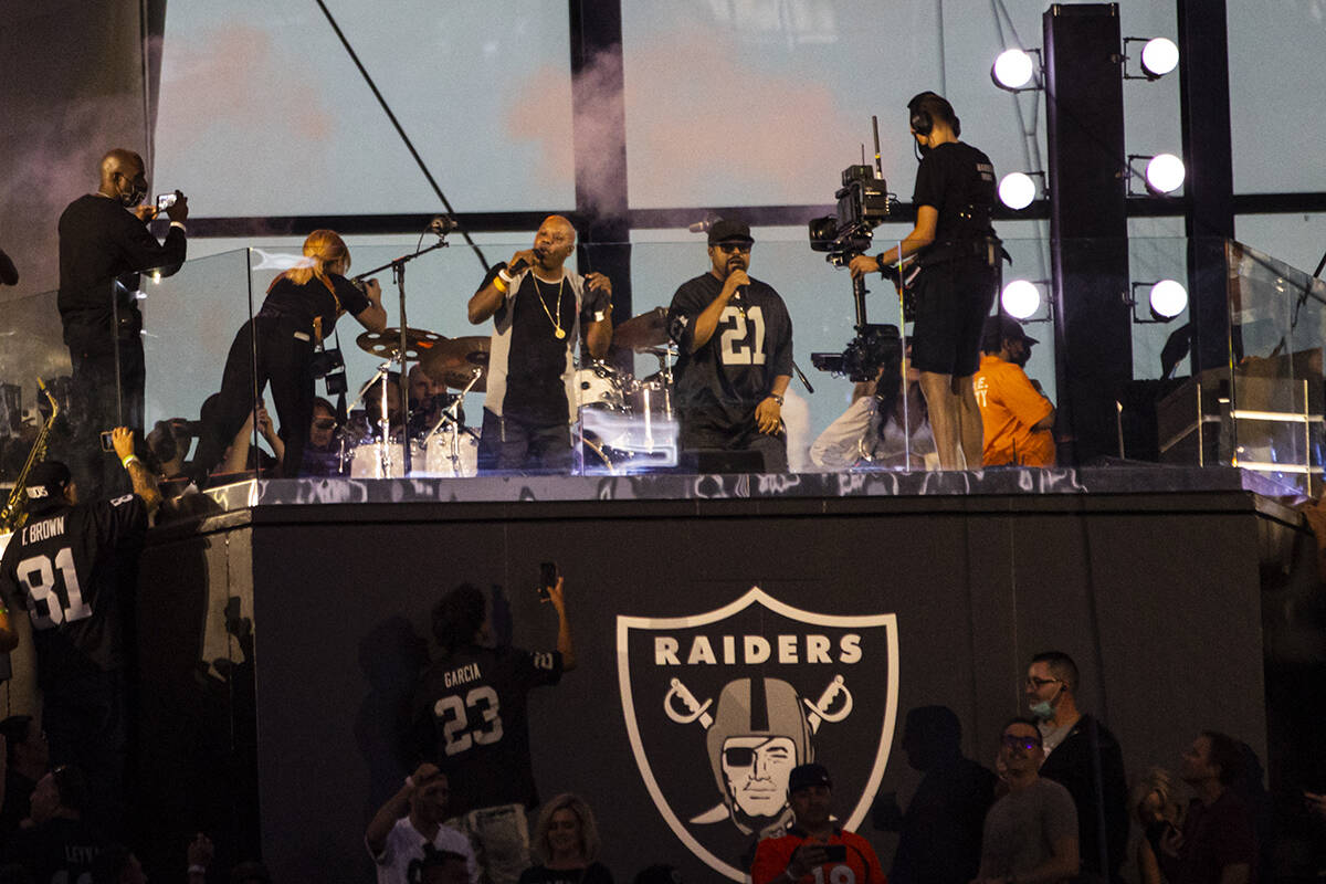 Too Short, center left, and Ice Cube perform during halftime at an NFL game between the Raiders ...