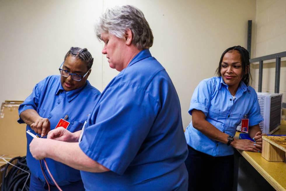 Students work on properly wiring digital thermostats during a HVAC class for inmates at Florenc ...