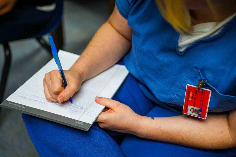 Kaitlyn Fugate writes down notes during a HVAC class for inmates at Florence McClure Women's Co ...