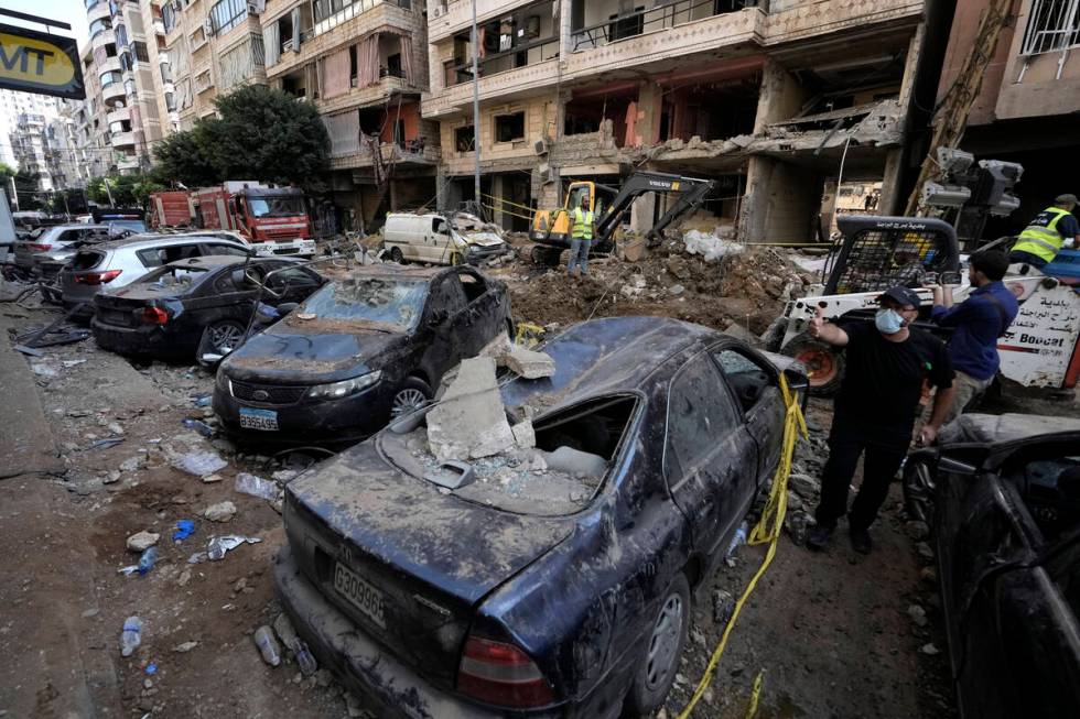 Damaged cars at the site of Friday's Israeli strike in Beirut's southern suburbs, Saturday, Sep ...