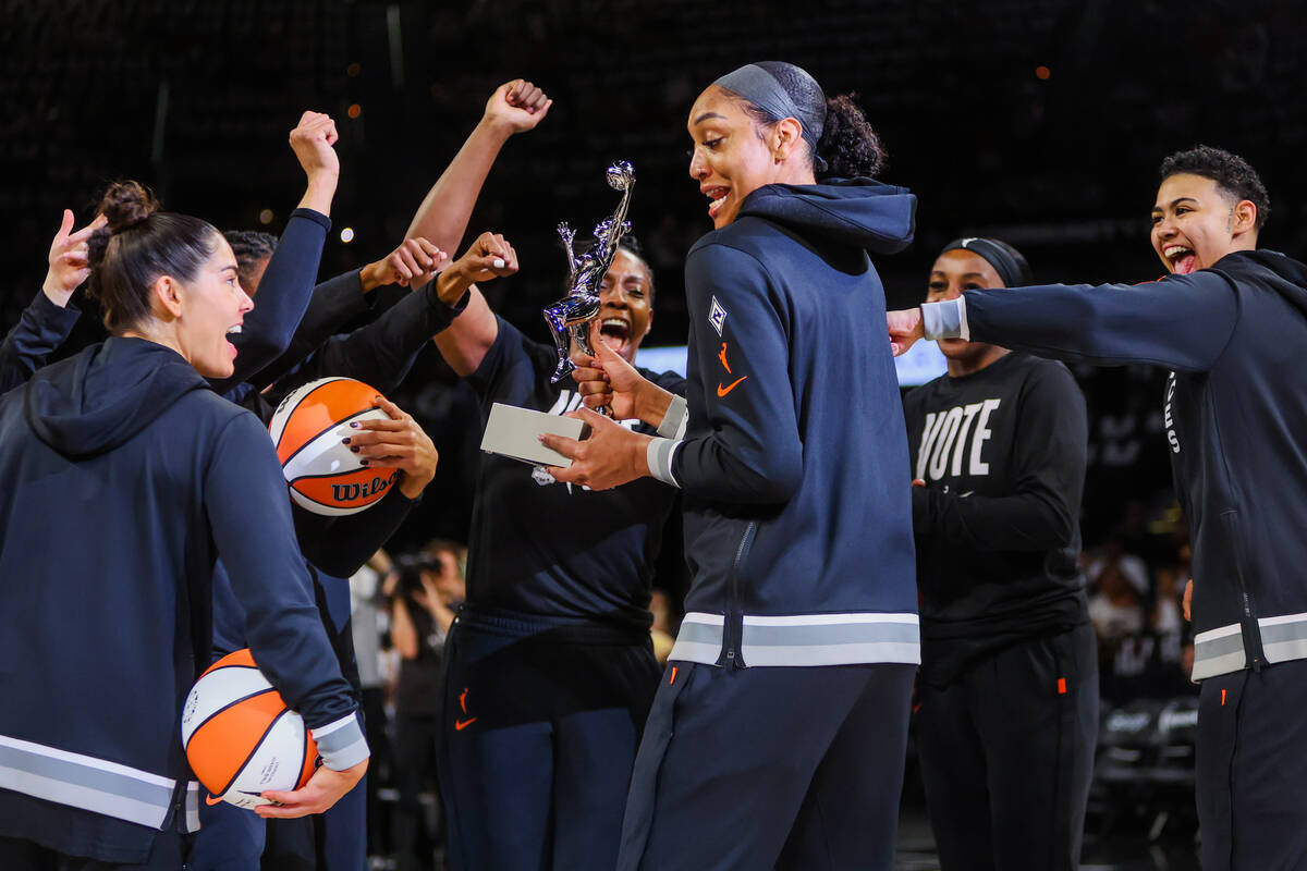 Aces center A'ja Wilson, middle, celebrates receiving a WNBA MVP trophy with her teammates befo ...