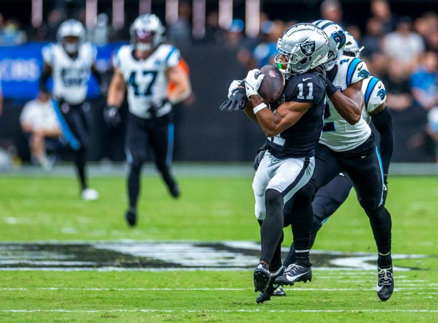 Raiders wide receiver Tre Tucker (11) looks in a long pass over Carolina Panthers cornerback Mi ...