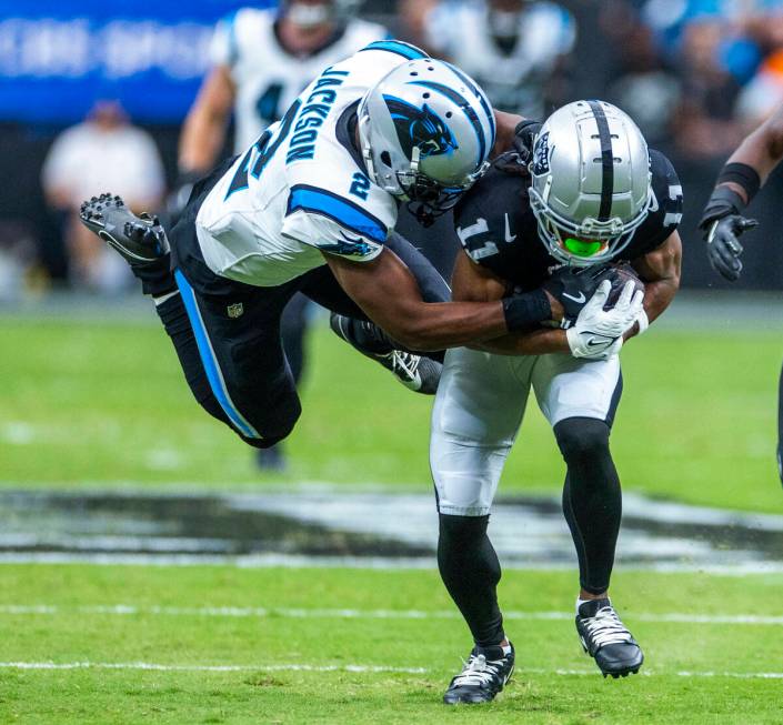 Raiders wide receiver Tre Tucker (11) secures a long pass over Carolina Panthers cornerback Mic ...