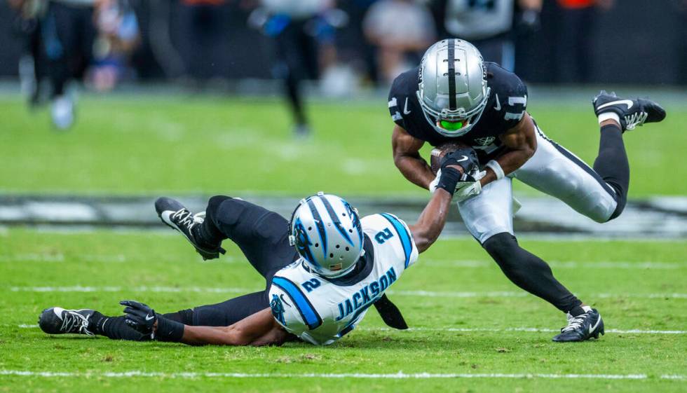 Raiders wide receiver Tre Tucker (11) holds onto a long pass as Carolina Panthers cornerback Mi ...