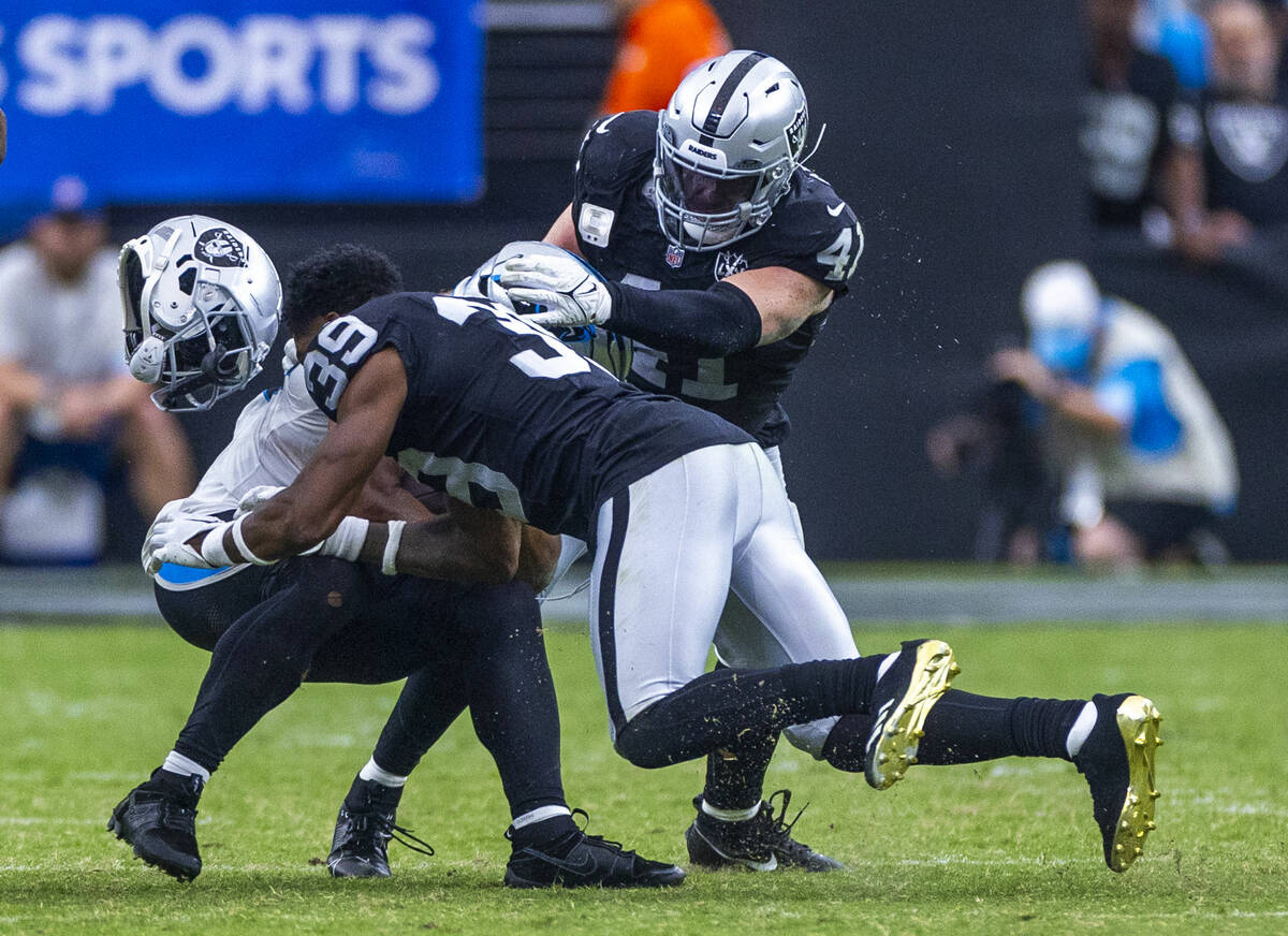 Raiders cornerback Nate Hobbs (39) loses his helmet on a tackle attempt on Carolina Panthers wi ...