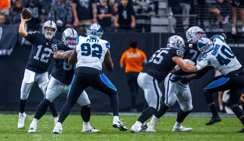 Raiders quarterback Aidan O'Connell (12) throws a late pass against the Carolina Panthers durin ...