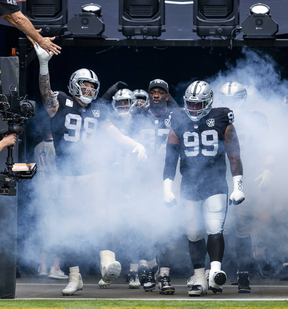 Raiders defensive end Maxx Crosby (98), defensive tackle Nesta Jade Silvera (99) and teammates ...