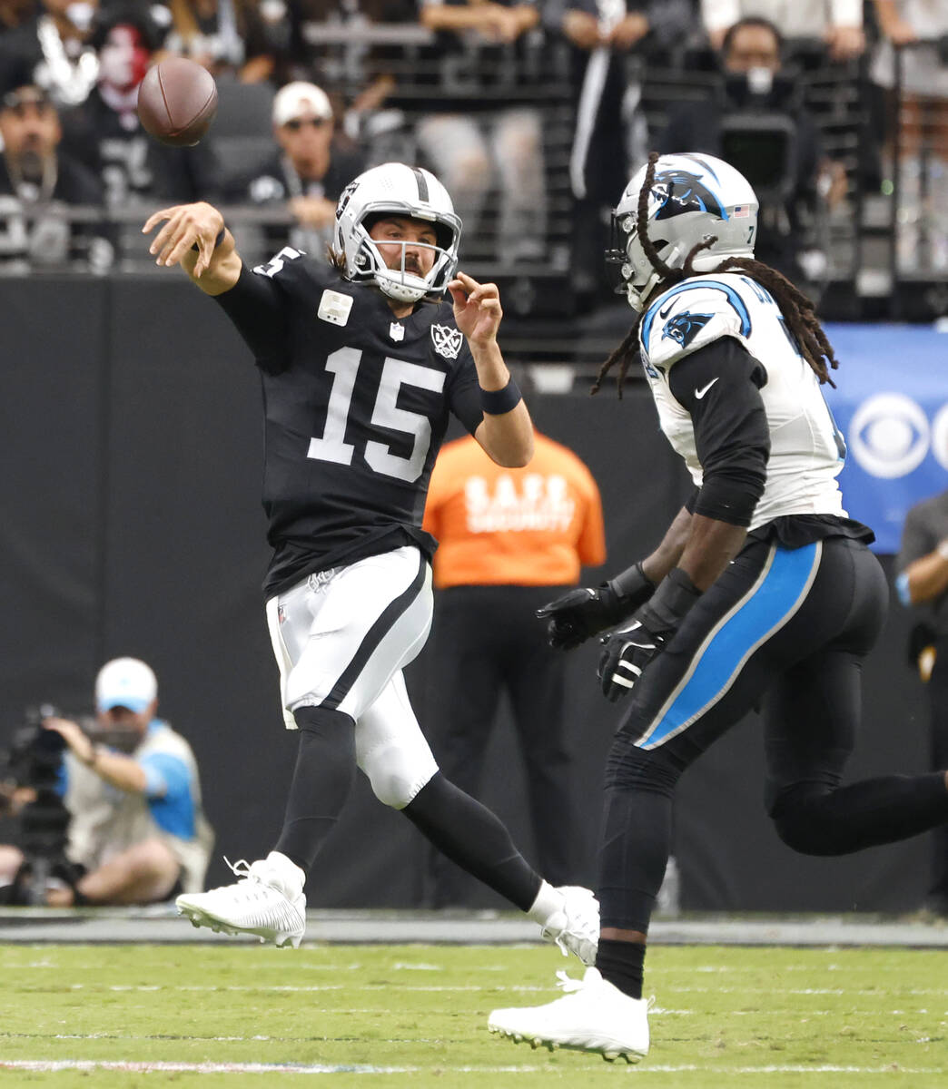 Raiders quarterback Gardner Minshew (15) throws under pressure from Carolina Panthers linebacke ...