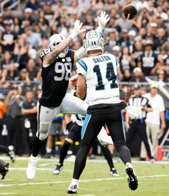 Raiders defensive end Maxx Crosby (98) deflects a pass from Carolina Panthers quarterback Andy ...