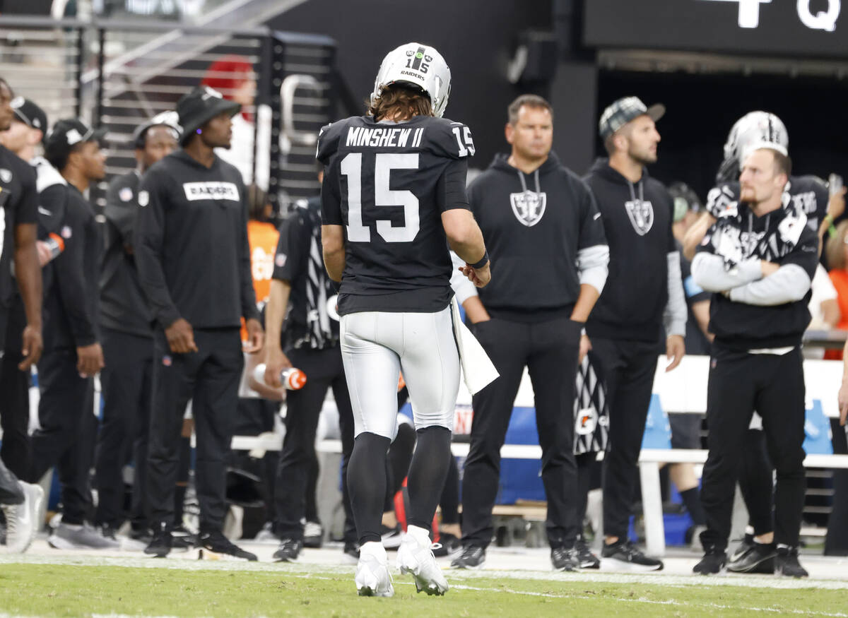 Raiders quarterback Gardner Minshew (15)walks off the field after his pass was intercepted by C ...