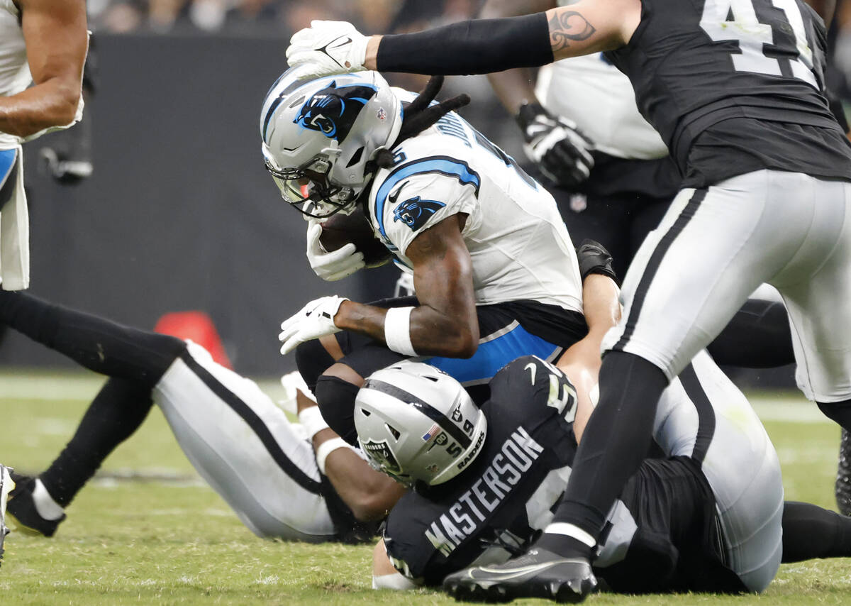 Raiders linebacker Luke Masterson (59) takes down Carolina Panthers linebacker DJ Johnson (52) ...