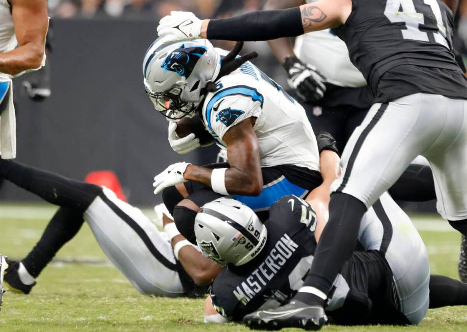 Raiders linebacker Luke Masterson (59) takes down Carolina Panthers linebacker DJ Johnson (52) ...