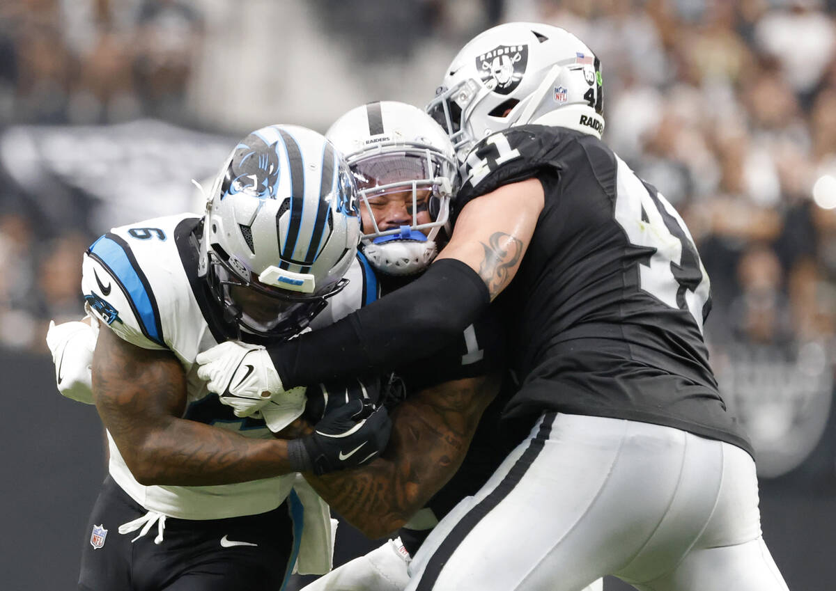 Carolina Panthers running back Miles Sanders (6) protects the ball from Carolina Panthers lineb ...