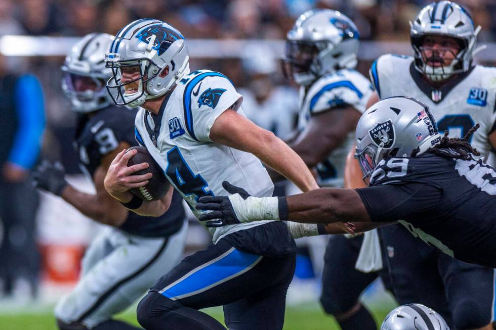 Carolina Panthers quarterback Andy Dalton (14) breaks free for a run as Raiders defensive tackl ...