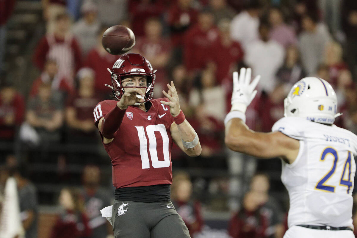 Washington State quarterback John Mateer (10) throws a pass next to San Jose State linebacker M ...