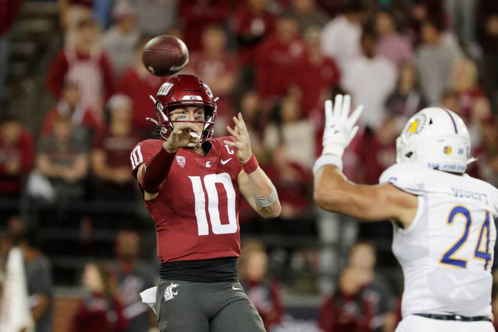 Washington State quarterback John Mateer (10) throws a pass next to San Jose State linebacker M ...