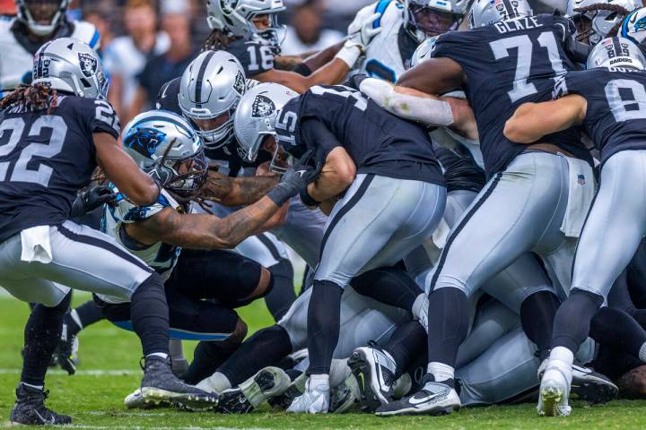 Raiders quarterback Gardner Minshew (15) is sacked by Carolina Panthers linebacker Shaq Thompso ...