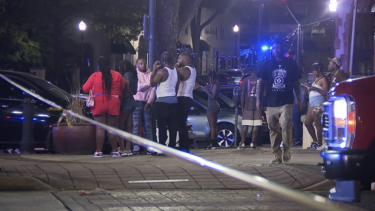 This image provided by WBMA shows bystanders near the scene of a shooting in Birmingham, Ala., ...