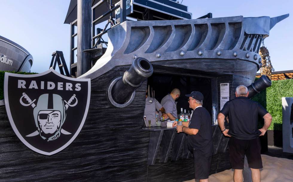 Fans step up the a pirate ship bar in the new Raiders Pregame Masqueraid venue in the tailgate ...