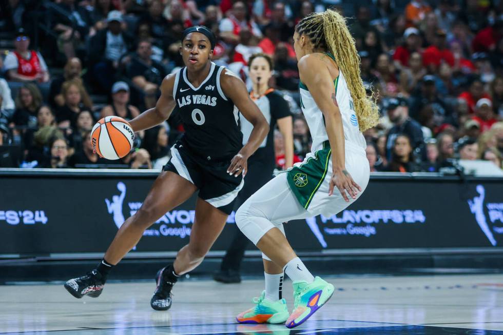 Aces guard Jackie Young (0) looks for an open teammate as Seattle Storm forward Gabby Williams ...