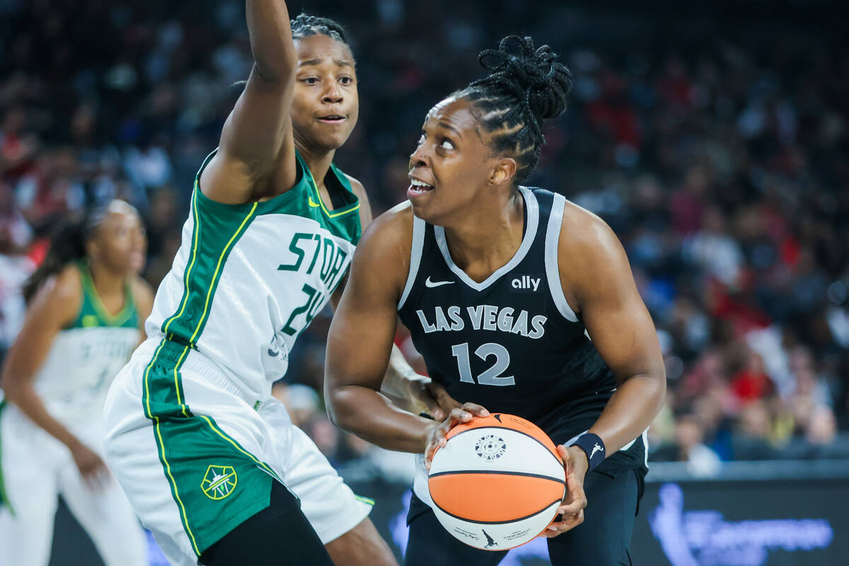 Aces guard Chelsea Gray (12) looks for space to shoot the ball as Seattle Storm guard Jewell Lo ...