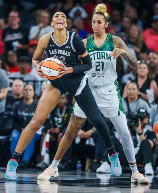 Aces center A'ja Wilson (22) struggles to find an opening to shoot the ball as Seattle Storm ce ...