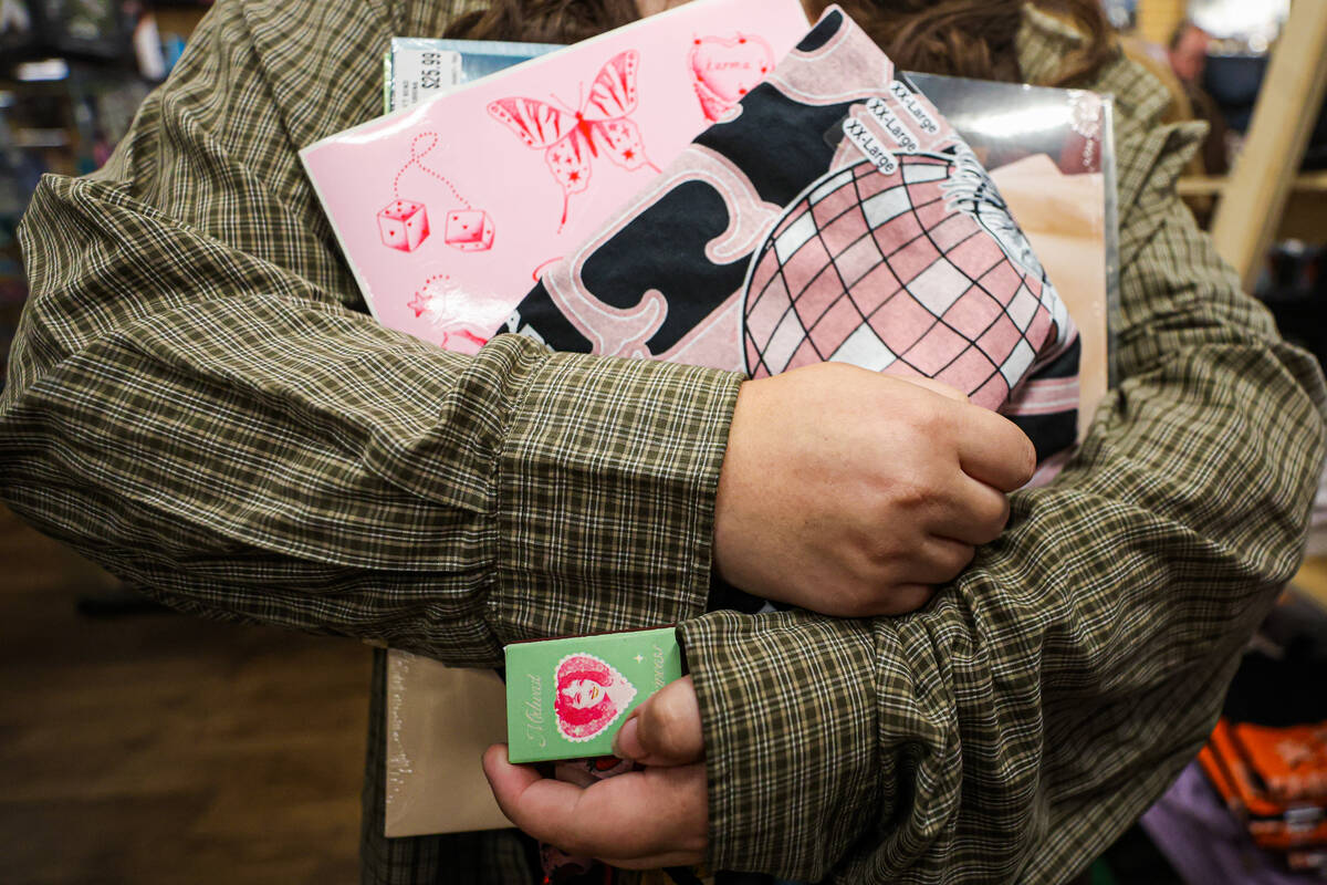 A Chappell roan fan holds a box of matches and other Chappell Roan merchandise during a listeni ...