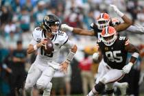 Jacksonville Jaguars quarterback Trevor Lawrence (16) scrambles for yardage as Cleveland Browns ...