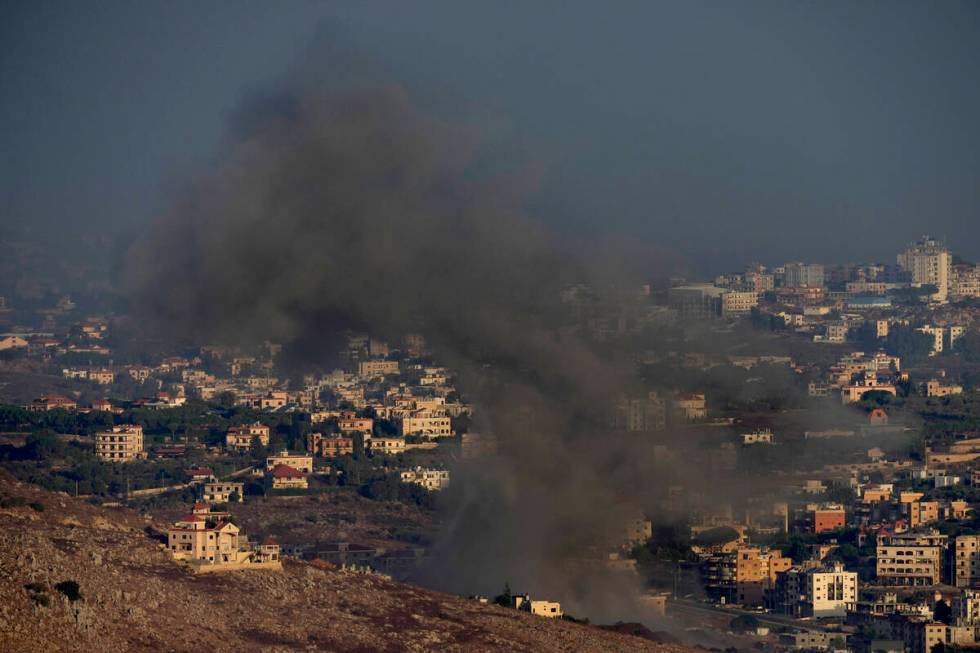 Smoke rises from an Israeli airstrike on Kfar Rouman village, as seen from Marjayoun town, sout ...