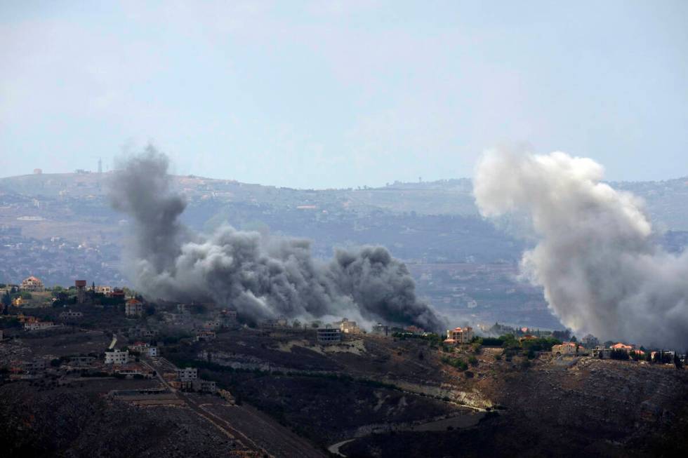 Smoke rises from Israeli airstrikes on Taybeh village, seen from the southern town of Marjayoun ...