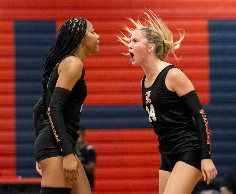 Liberty sophomore Addison Jones (14) and Liberty senior Kennedy Cooper (3) celebrate after a bl ...