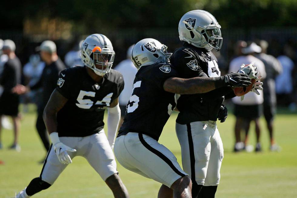 From left, Oakland Raiders linebackers Brandon Marshall, Vontaze Burfict and Te'Von Coney take ...