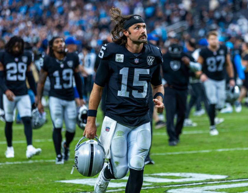 Raiders quarterback Gardner Minshew (15) runs off the field after losing to the Carolina Panthe ...