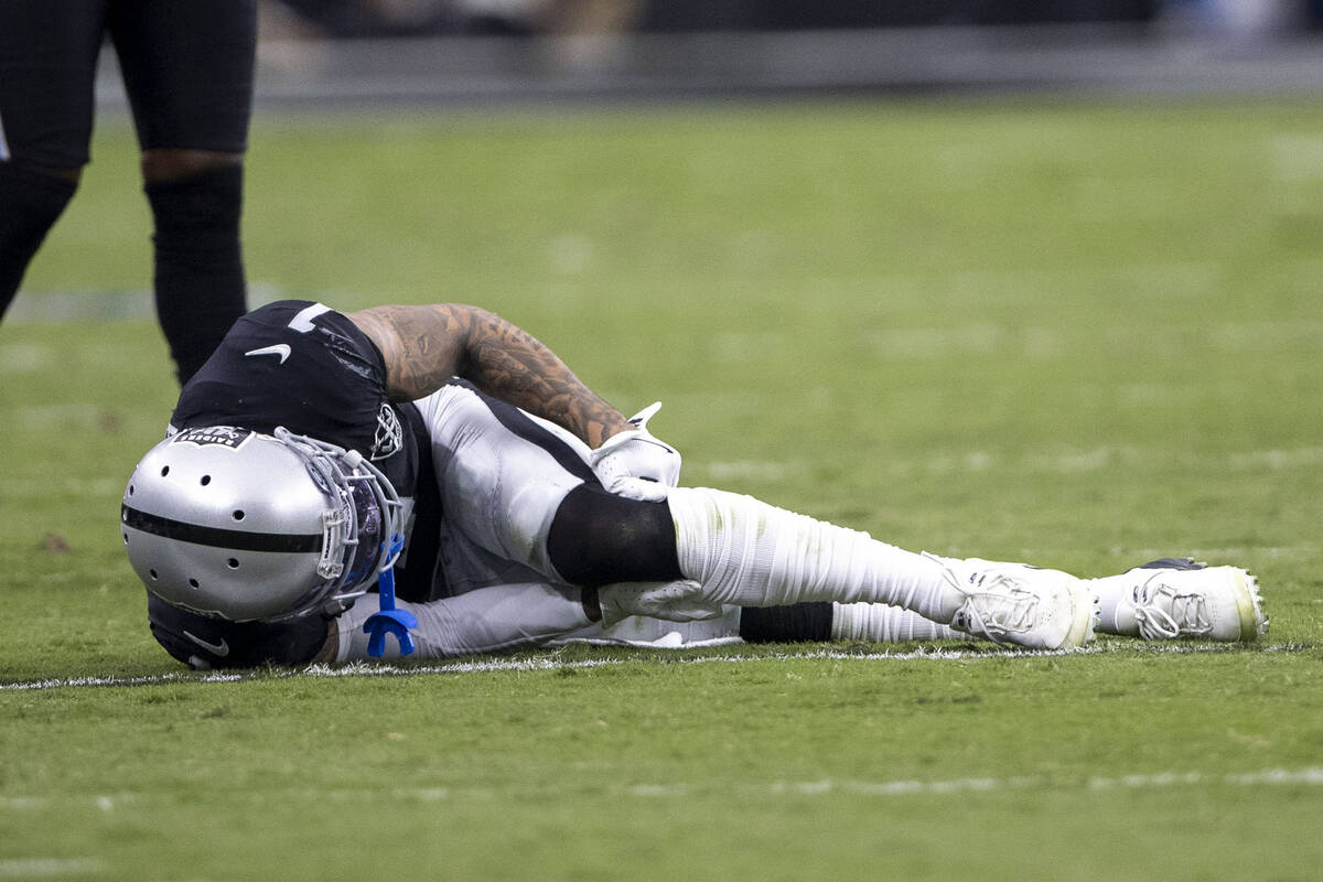 Raiders safety Marcus Epps (1) grabs at his knee as he lays injured on the field during the sec ...