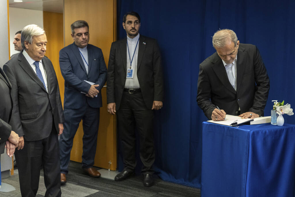 U.N. Secretary-General Antonio Guterres, left, looks on as the President of Iran, Masoud Pezesh ...