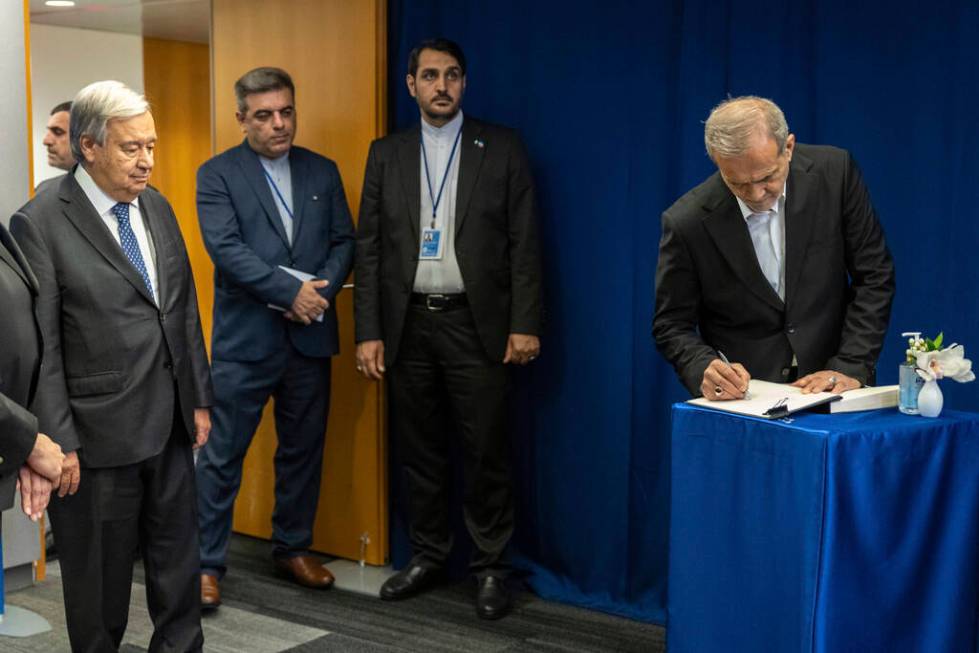 U.N. Secretary-General Antonio Guterres, left, looks on as the President of Iran, Masoud Pezesh ...