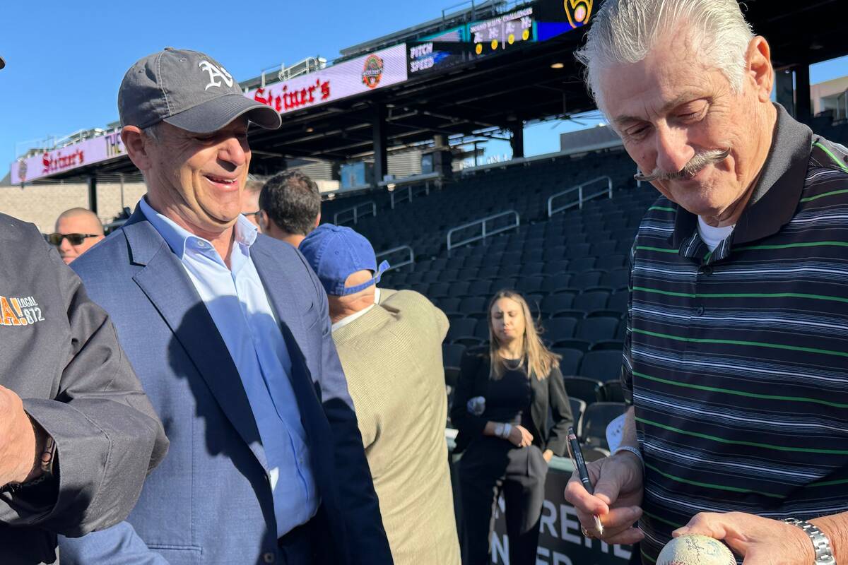 FILE - Oakland Athletics owner John Fisher (left) and A's hall of fame pitcher Rollie Fingers s ...