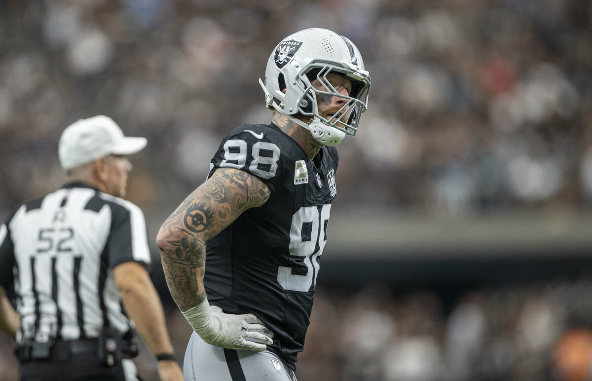 Raiders defensive end Maxx Crosby (98) looks to replay after a big play from the Carolina Panth ...