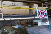 Caution tape is wrapped about a carport area as water pools along Natalee Drive as a result of ...