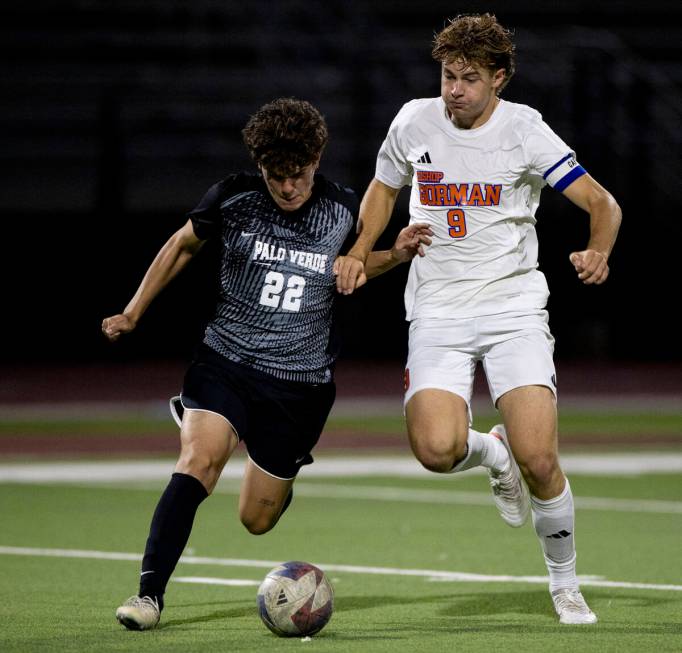 Palo Verde midfielder Trustin Parker (22) and Bishop Gorman forward Chase Stewart (9) compete f ...