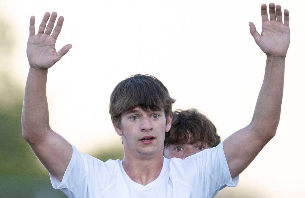 Palo Verde defender Jaxon Law, back, prepares for a corner kick, watching over the shoulders of ...