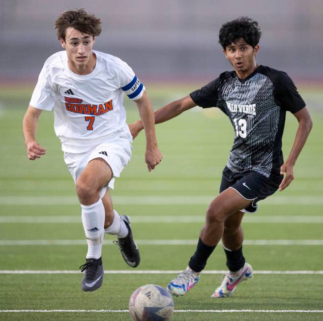 Bishop Gorman midfielder Maddix Bordinhao (7) and Palo Verde sophomore Haydn Rodrigues (13) run ...