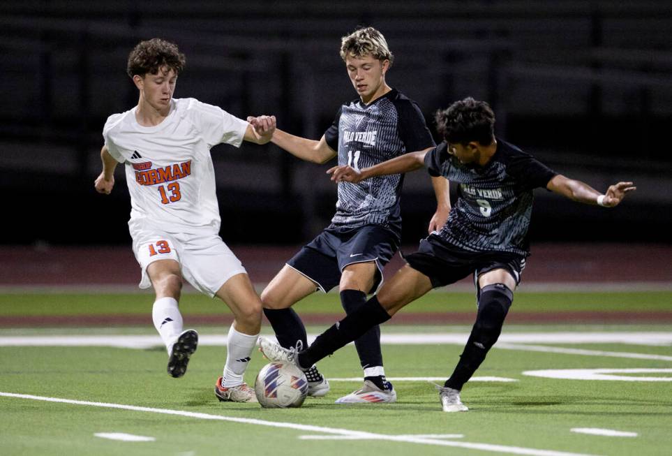 Bishop Gorman and Palo Verde players compete for the ball during the high school soccer game at ...