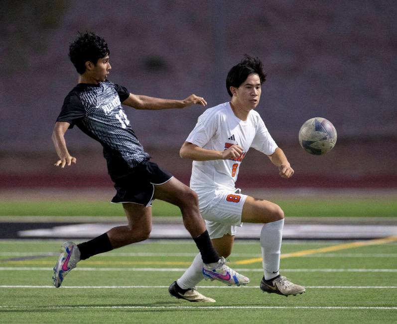 Palo Verde sophomore Haydn Rodrigues (13) and Bishop Gorman midfielder Rockwell Rabago (8) comp ...