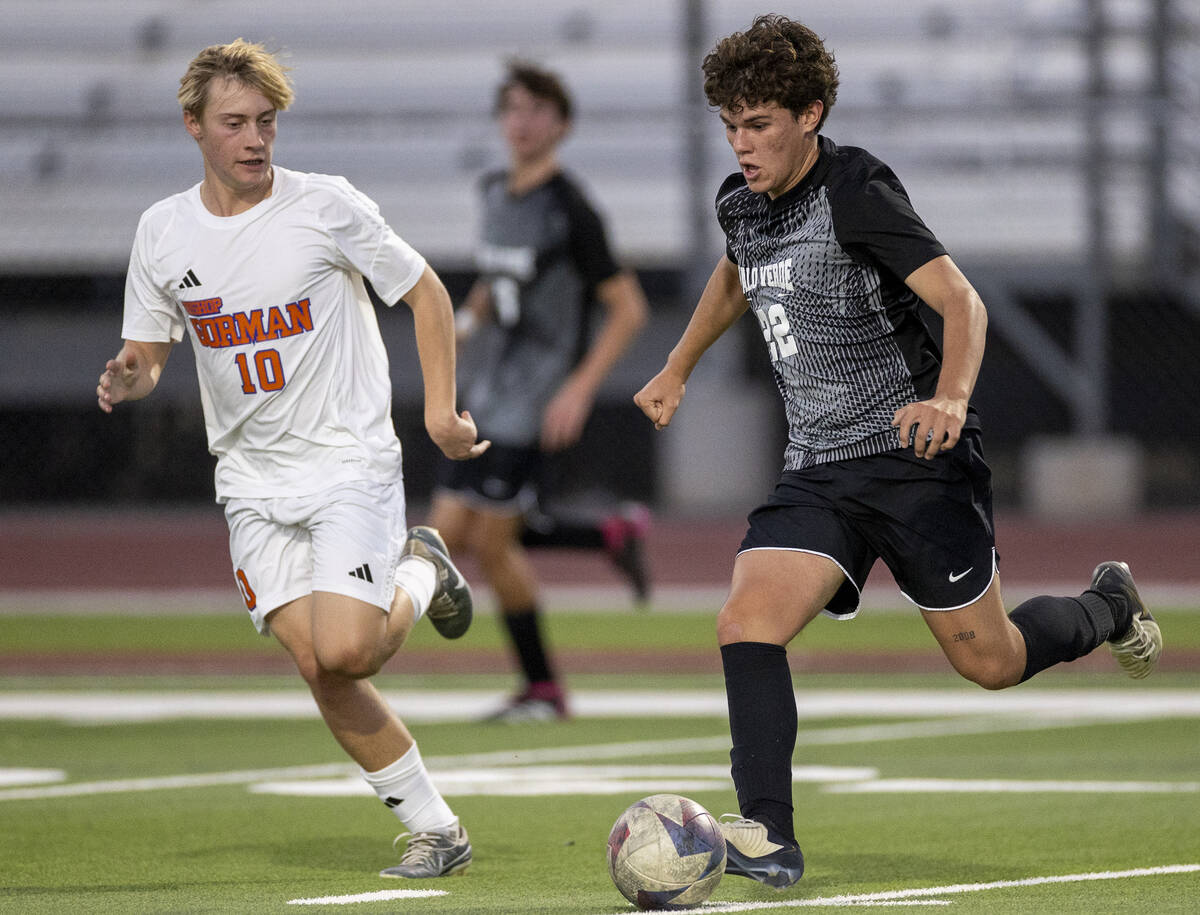 Bishop Gorman midfielder Jacob Swift (10) and Palo Verde midfielder Trustin Parker (22) compete ...