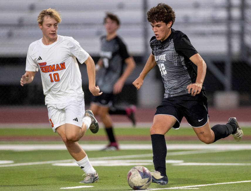 Bishop Gorman midfielder Jacob Swift (10) and Palo Verde midfielder Trustin Parker (22) compete ...