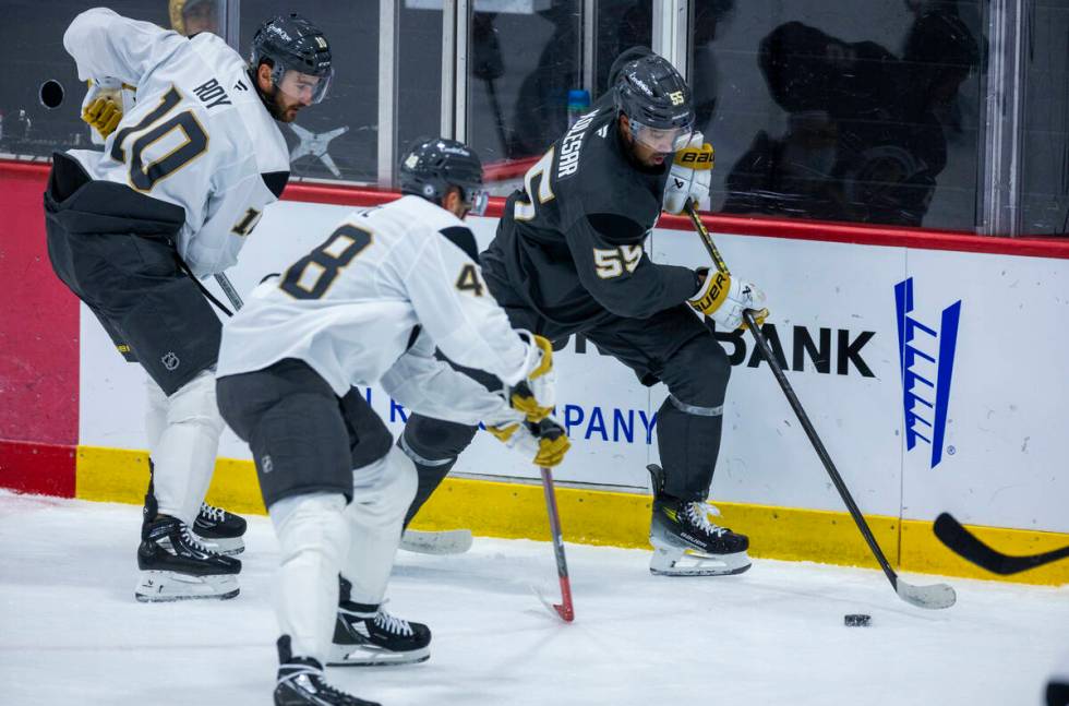 Golden Knights right wing Keegan Kolesar (55) controls the puck against center Tomas Hertl (48) ...