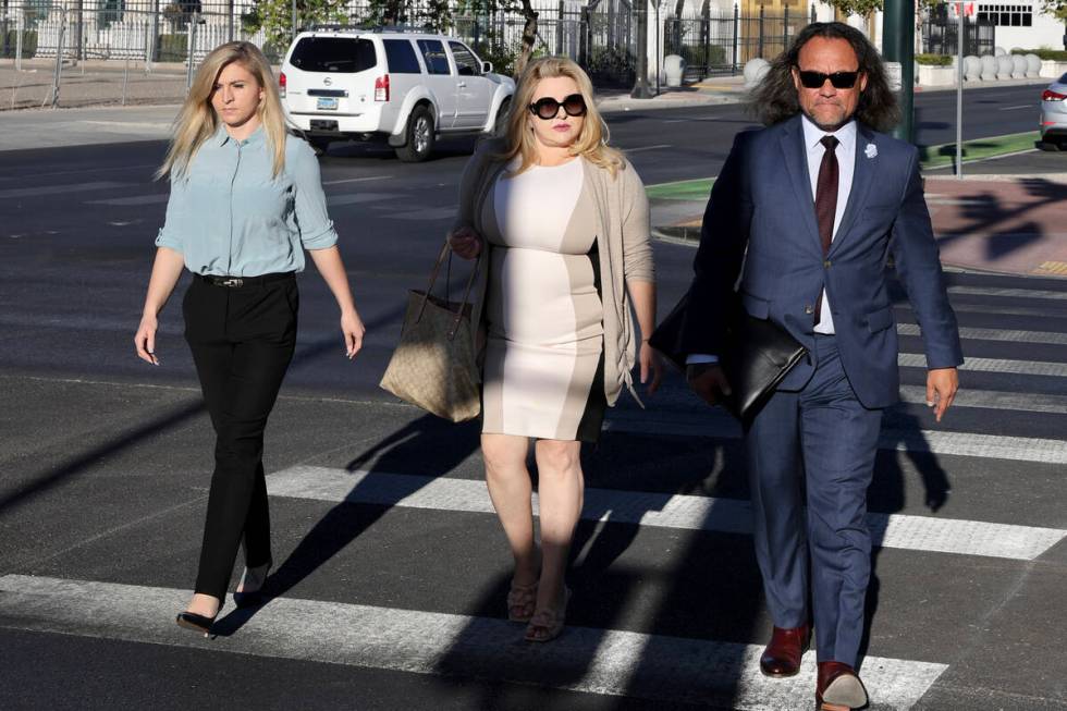 Former Las Vegas Councilwoman Michele Fiore, center, walks to the Lloyd George U.S. Courthouse ...