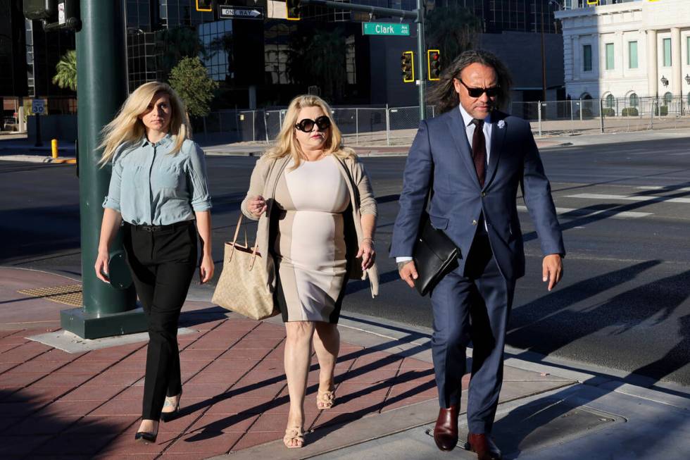 Former Las Vegas Councilwoman Michele Fiore, center, walks to the Lloyd George U.S. Courthouse ...