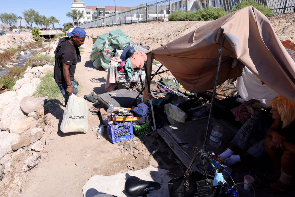 FILE - People camp along the Tropicana Wash near University Center Drive east of the Strip in L ...